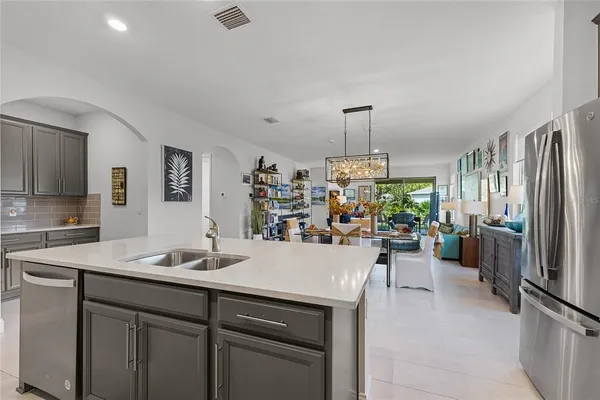 a kitchen with a sink appliances and cabinets