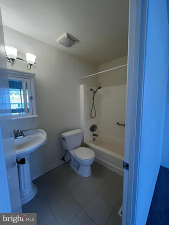a bathroom with a sink toilet a mirror and shower