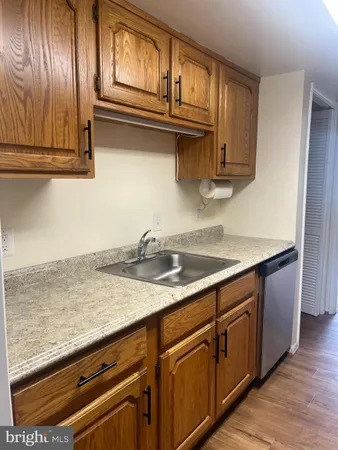a kitchen with stainless steel appliances granite countertop a sink and cabinets