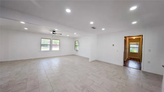 an empty room with windows and closet