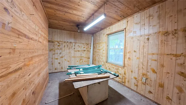 a room with granite countertop a sink and a shower