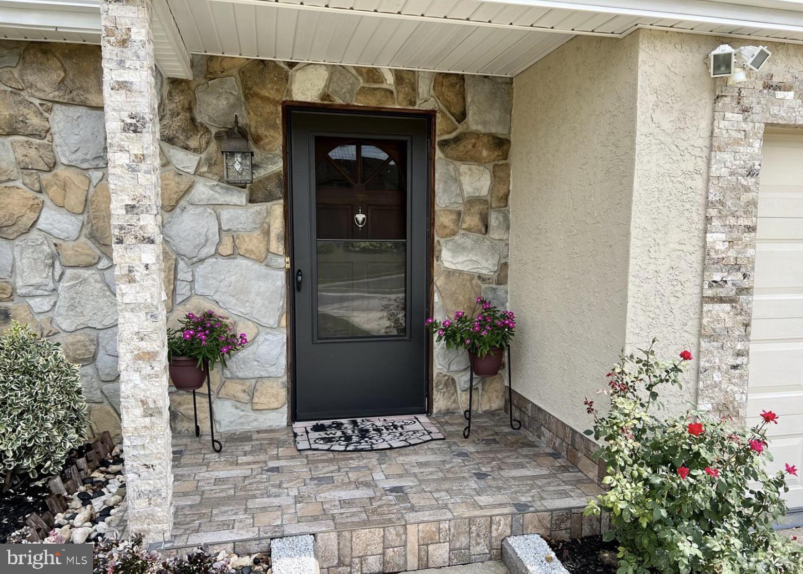52 Sandpiper Drive Voorhees, NJ 08043 - Photo 3 of 26 a vase of flowers sitting on a brick wall