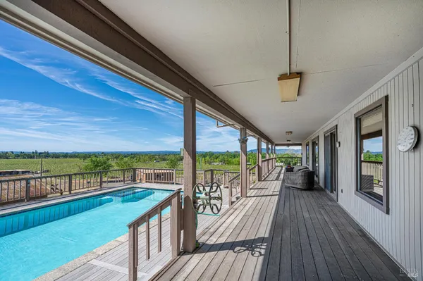 a view of a house with swimming pool and sitting area