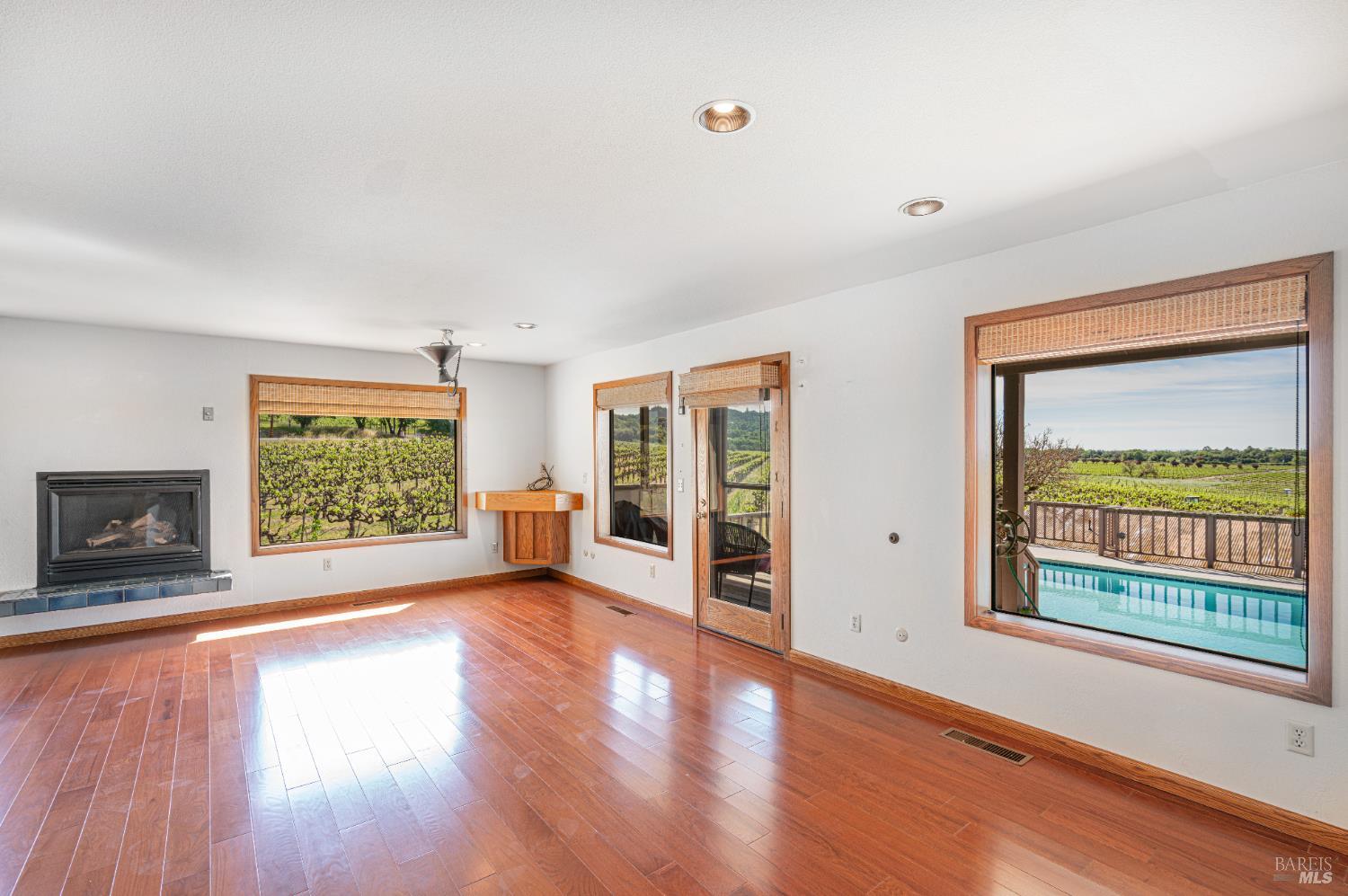590 Pleasant Avenue Santa Rosa, CA 95403 - Photo 27 of 84 a view of an empty room with wooden floor and a window