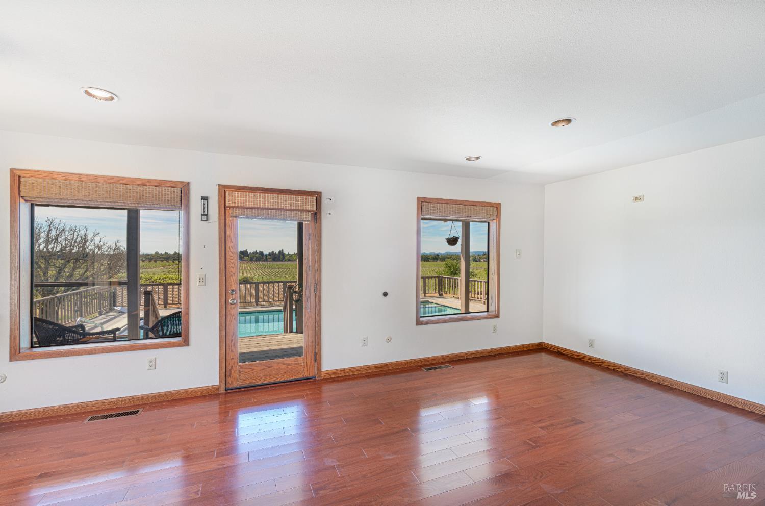 590 Pleasant Avenue Santa Rosa, CA 95403 - Photo 28 of 84 an empty room with wooden floor and windows