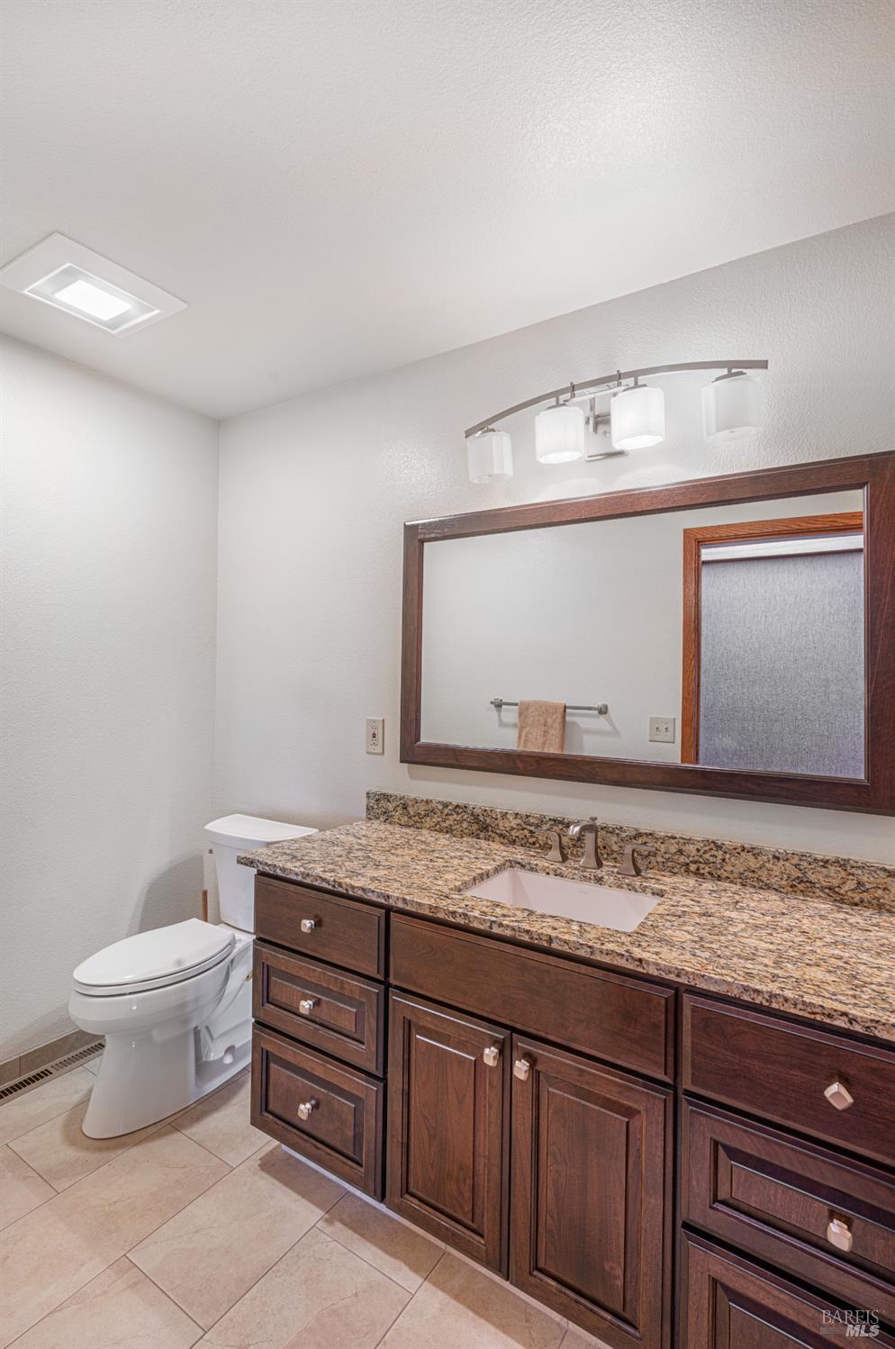 590 Pleasant Avenue Santa Rosa, CA 95403 - Photo 38 of 84 a bathroom with a granite countertop sink mirror and toilet