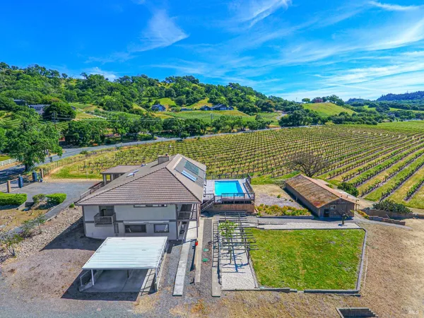 an aerial view of a house with a ocean view