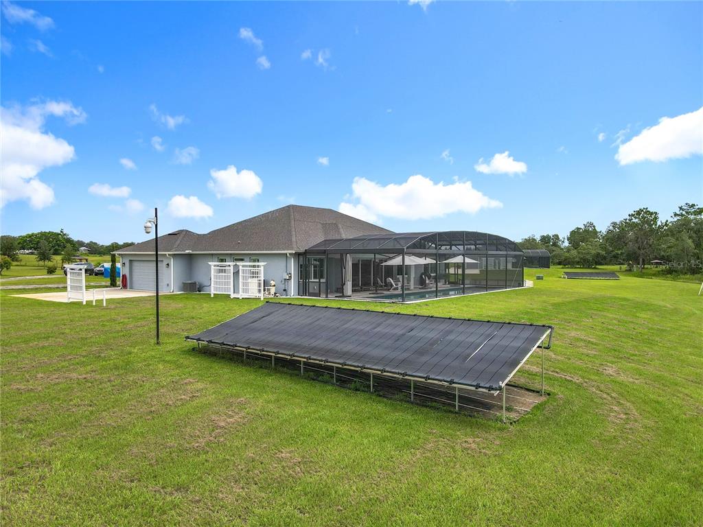 10220 Bay Lake Road Groveland, FL 34736 - Photo 46 of 67 a front view of a house with swimming pool having outdoor seating