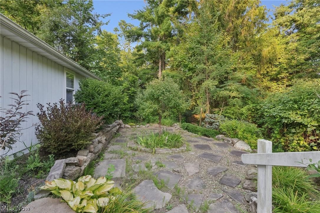 10571 Mayfield Road Chesterland, OH 44026 - Photo 22 of 39 Stone patio off of garage - a wonderful private spot surrounded by woods and yard.