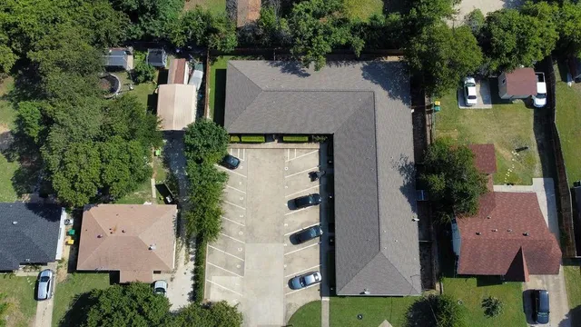 an aerial view of multiple houses with yard