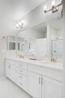 a bathroom with a sink vanity and mirror