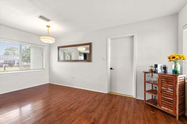 a view of a room with wooden floor windows and cabinet