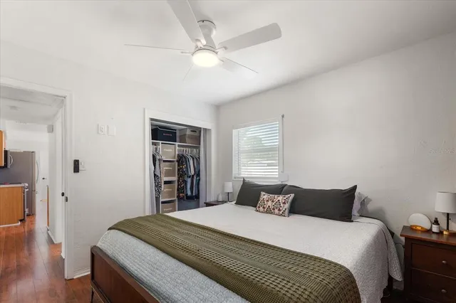 a bedroom with a large bed and a chandelier