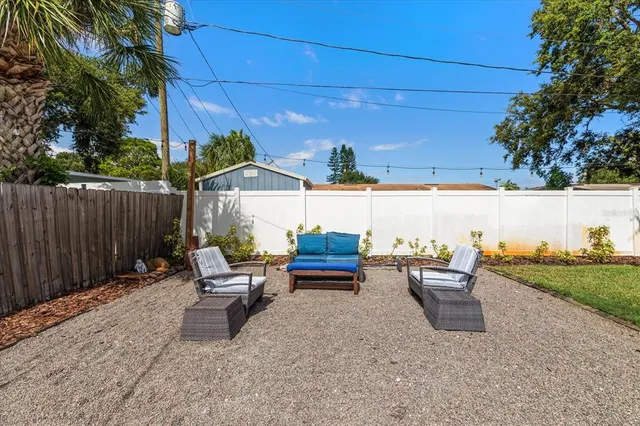 a backyard of a house with yard and outdoor seating