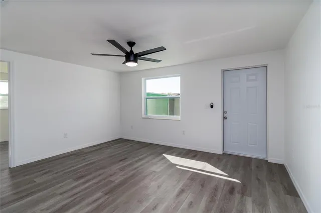 wooden floor in an empty room with a window