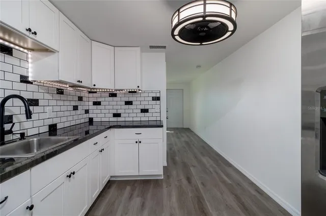 a kitchen with a sink and cabinets
