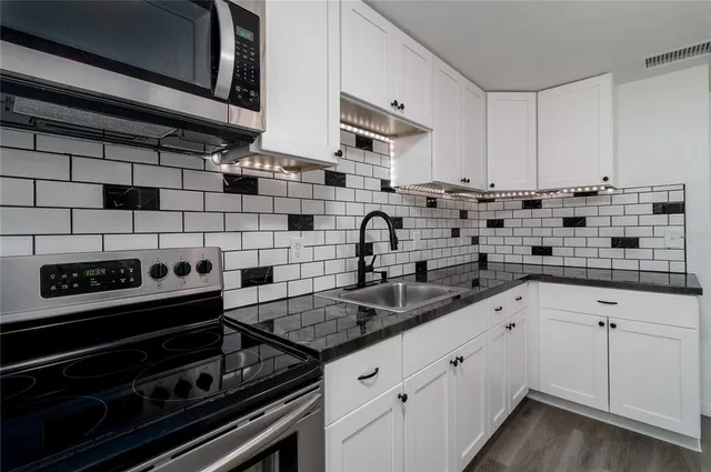 a kitchen with sink and stove