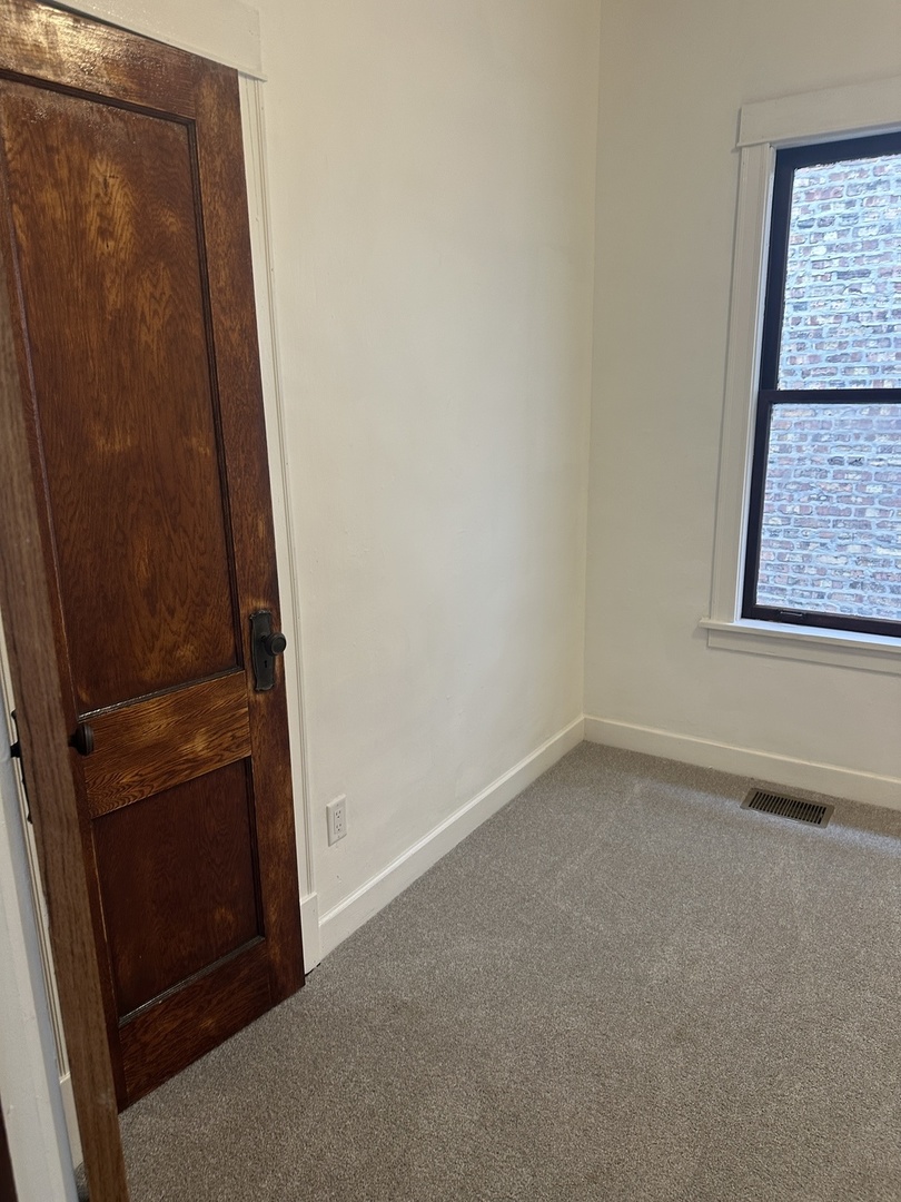 8634 South Carpenter Street Chicago, IL 60620 - Photo 18 of 28 an empty room with a door