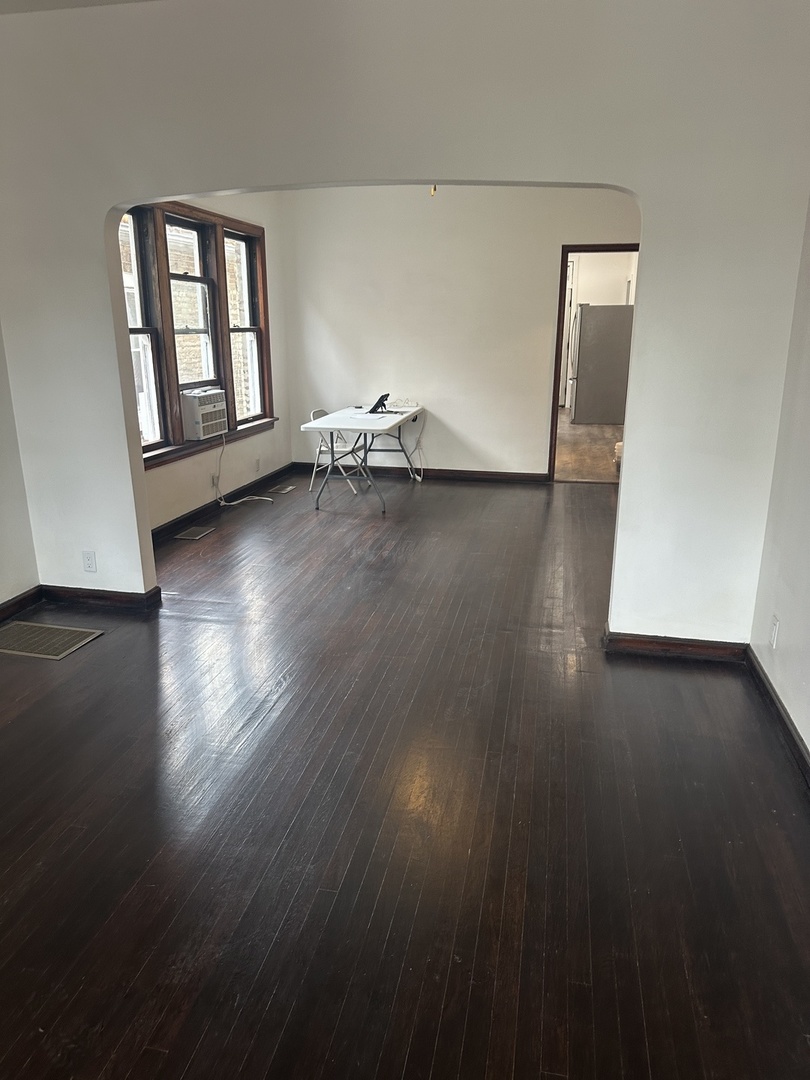 8634 South Carpenter Street Chicago, IL 60620 - Photo 5 of 28 an empty room with wooden floor and windows