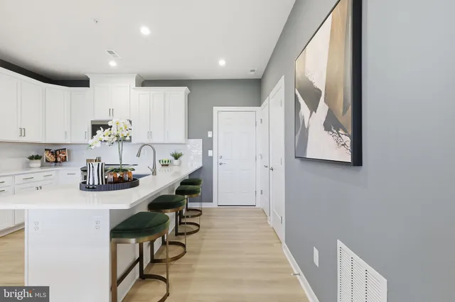 a kitchen with stainless steel appliances a refrigerator and a sink