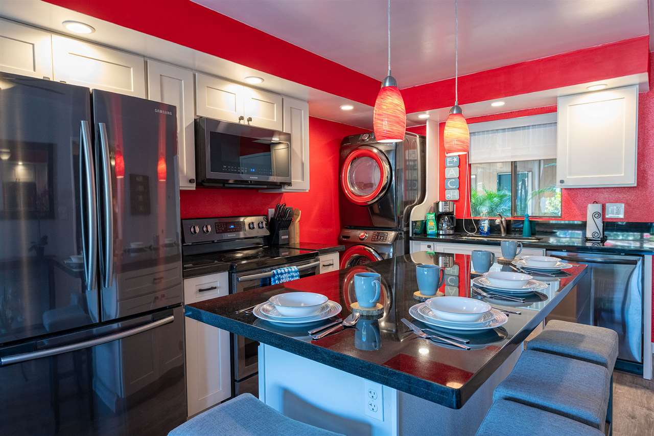 2219 South Kihei Road, Unit B104 Kihei, HI 96753 - Photo 14 of 27 a kitchen with stainless steel appliances granite countertop a stove a refrigerator and a microwave