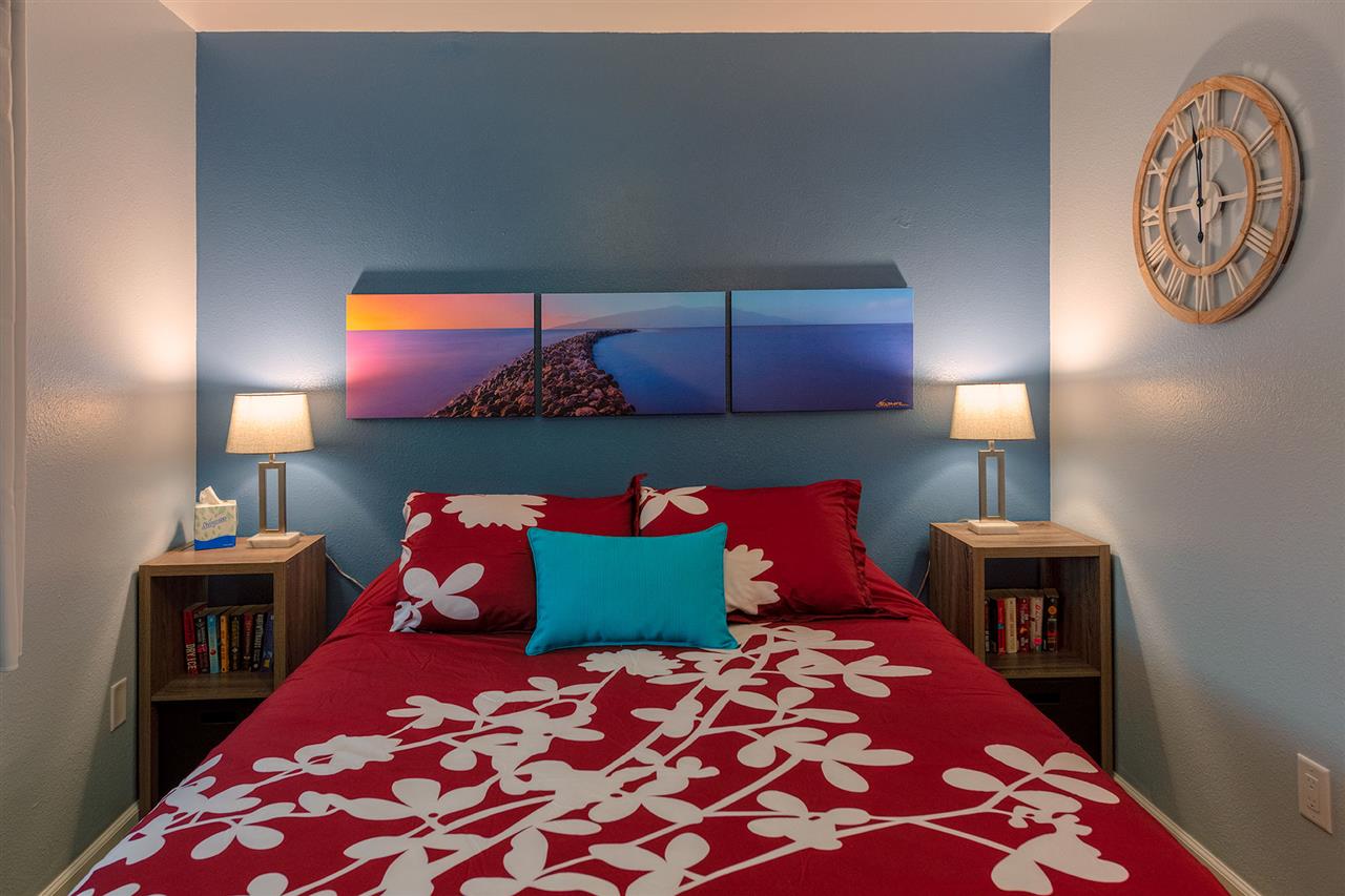 2219 South Kihei Road, Unit B104 Kihei, HI 96753 - Photo 19 of 27 a bedroom with a bed and a lamp on dresser