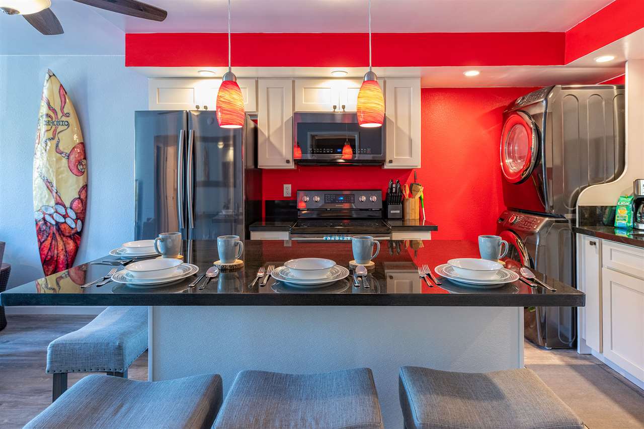 2219 South Kihei Road, Unit B104 Kihei, HI 96753 - Photo 2 of 27 a room with lots of chairs and wooden floor