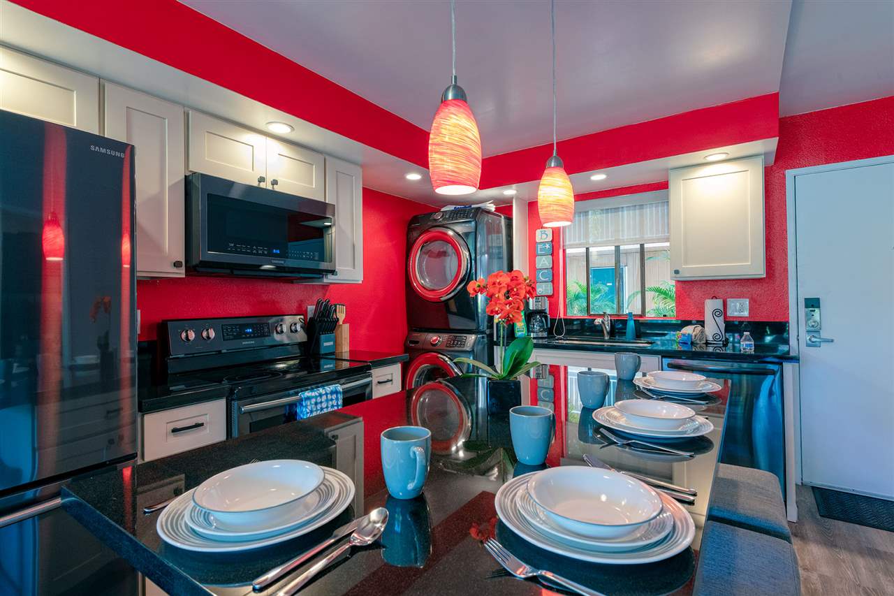 2219 South Kihei Road, Unit B104 Kihei, HI 96753 - Photo 24 of 27 a room that has a couch and a dining table with wooden floor