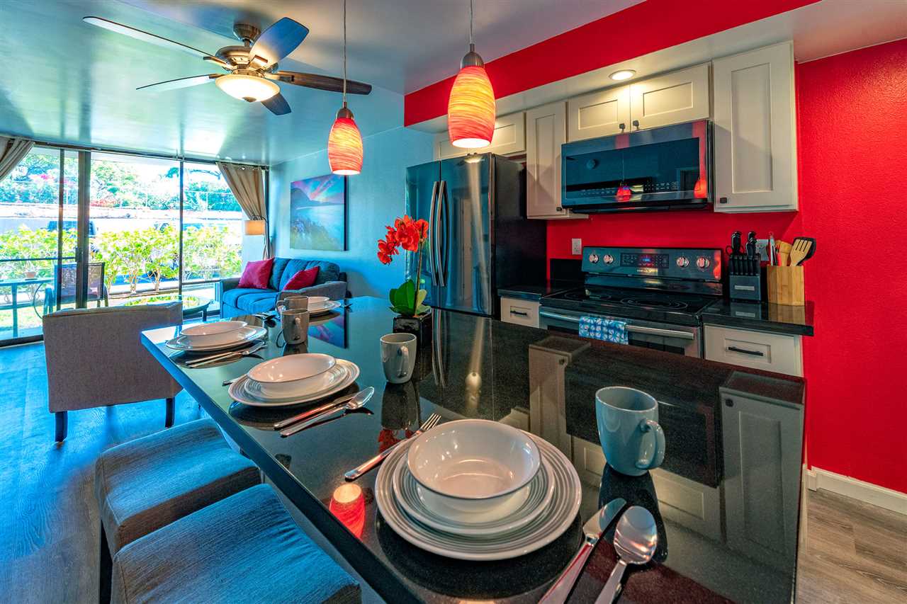 2219 South Kihei Road, Unit B104 Kihei, HI 96753 - Photo 3 of 27 a room with furniture a flat screen tv and a floor to ceiling window