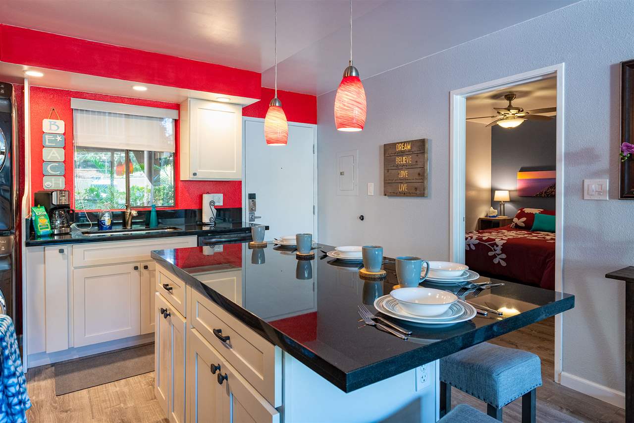 2219 South Kihei Road, Unit B104 Kihei, HI 96753 - Photo 4 of 27 a kitchen with a table chairs and a stove