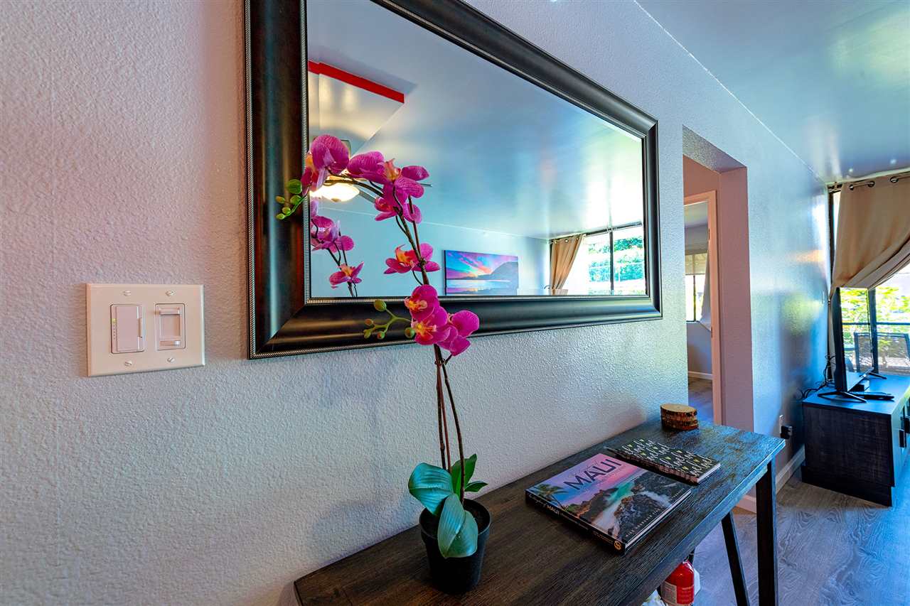 2219 South Kihei Road, Unit B104 Kihei, HI 96753 - Photo 6 of 27 a living room with furniture and flowers