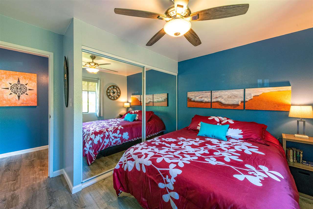 2219 South Kihei Road, Unit B104 Kihei, HI 96753 - Photo 7 of 27 a bedroom with a bed and two large window