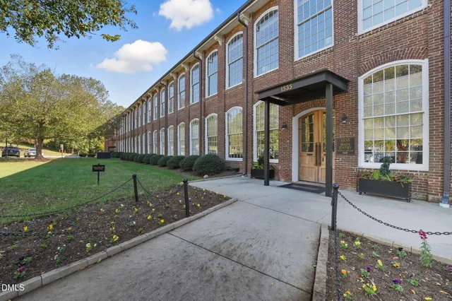 a view of a building with a yard