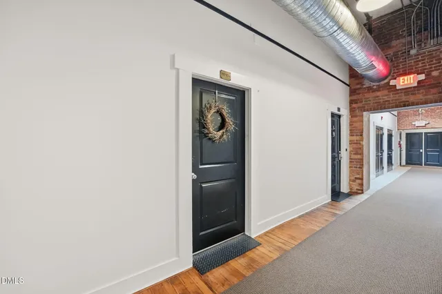 a view of a hallway with wooden shelves