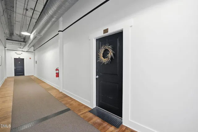 a view of a room with wooden floor