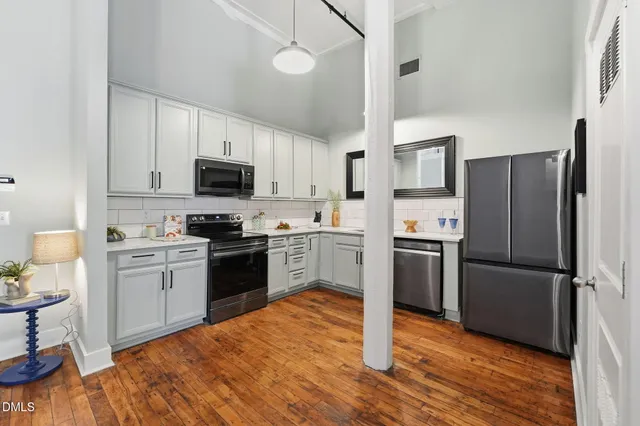 a view of a living room with wooden floor