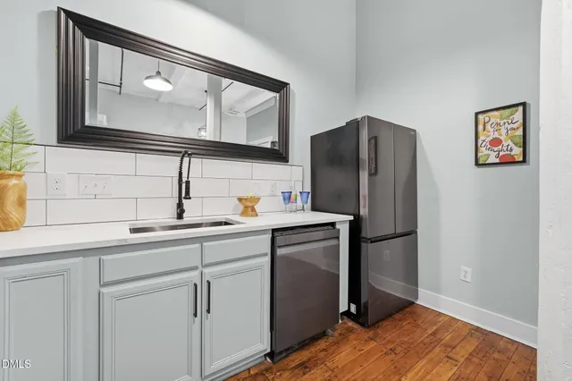 a kitchen with stainless steel appliances a refrigerator and a sink