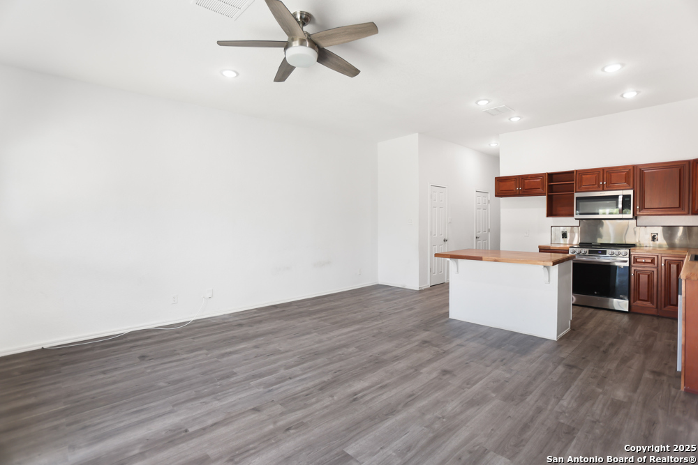 8611 Key Windy Way, Unit 2 Converse, TX 78109 - Photo 11 of 26 a view of kitchen with stainless steel appliances wooden floor and window