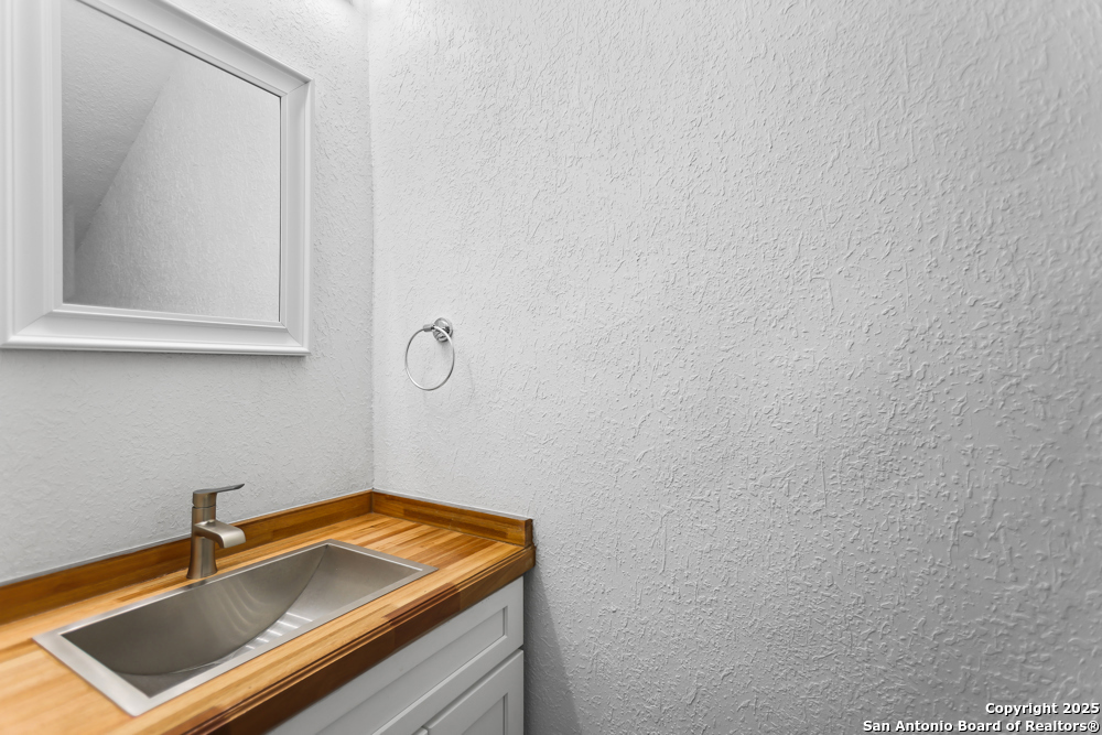 8611 Key Windy Way, Unit 2 Converse, TX 78109 - Photo 13 of 26 a bathroom with a sink and a mirror