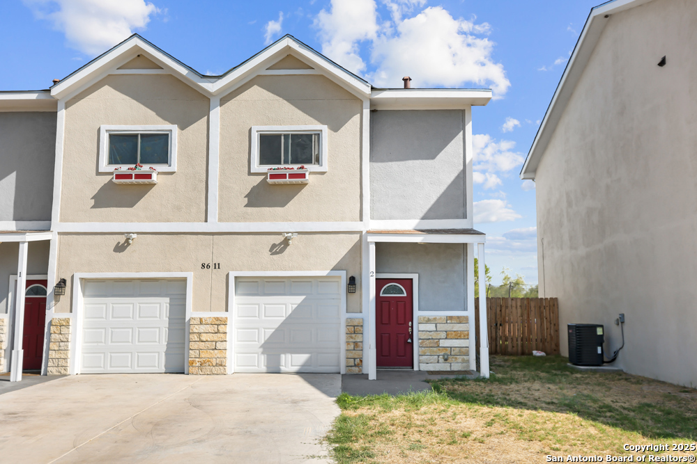 8611 Key Windy Way, Unit 2 Converse, TX 78109 - Photo 2 of 26 a front view of a house with garden