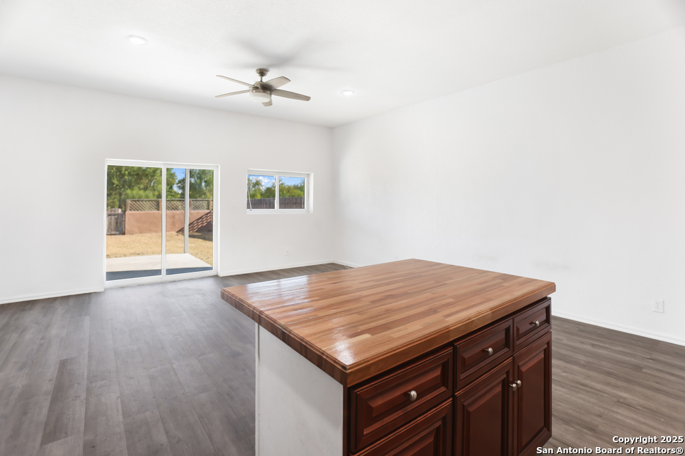 8611 Key Windy Way, Unit 2 Converse, TX 78109 - Photo 8 of 26 an empty room with wooden floor and fan