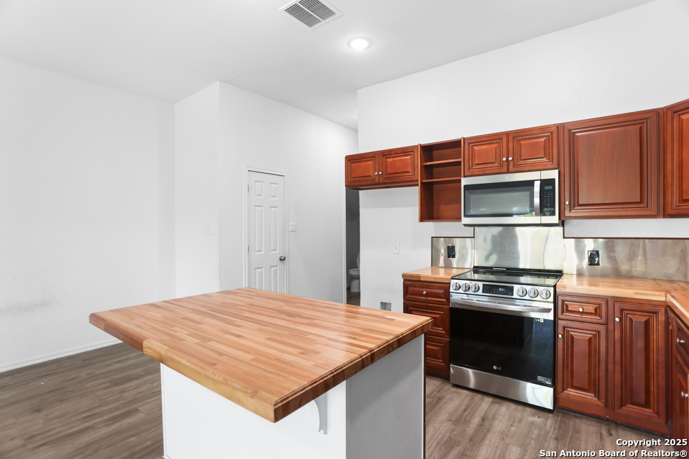 8611 Key Windy Way, Unit 2 Converse, TX 78109 - Photo 9 of 26 a kitchen with a stove and a microwave