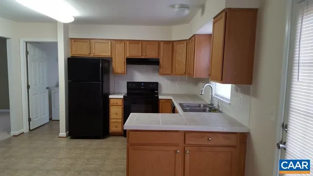 a kitchen with a sink and a refrigerator