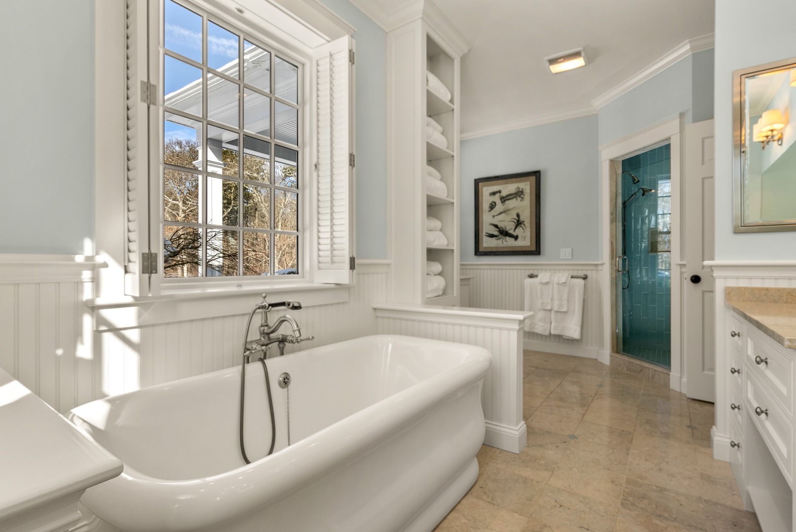 243 Katama Road Edgartown, MA 02539 - Photo 16 of 42 a bathroom with a tub a sink and a large mirror next to a window