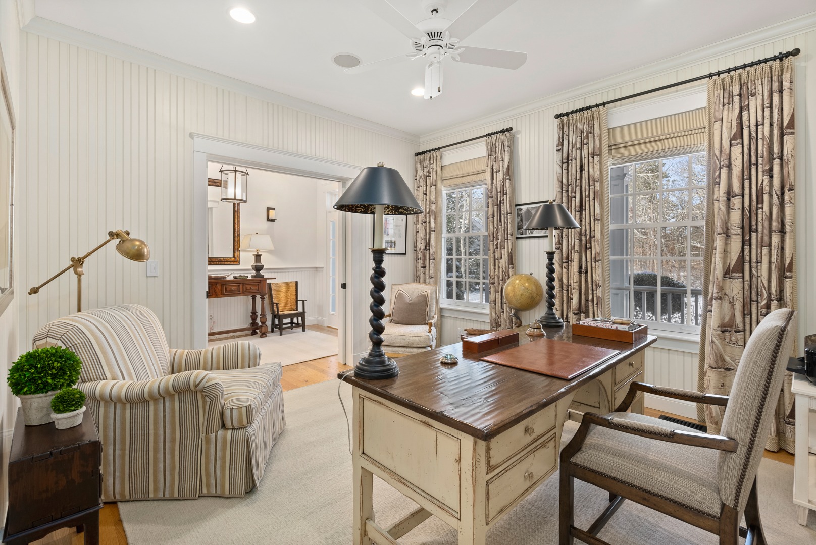 243 Katama Road Edgartown, MA 02539 - Photo 19 of 42 a living room with furniture a large window and a chandelier