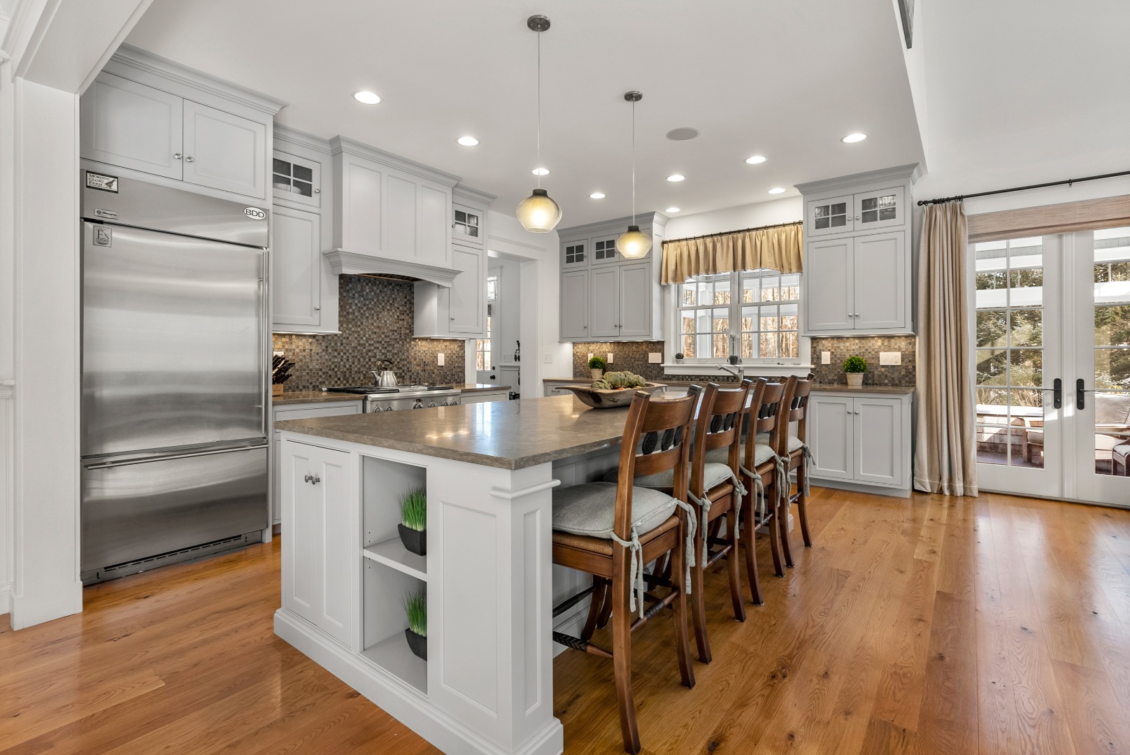 243 Katama Road Edgartown, MA 02539 - Photo 5 of 42 a kitchen with stainless steel appliances kitchen island granite countertop a table chairs sink and cabinets