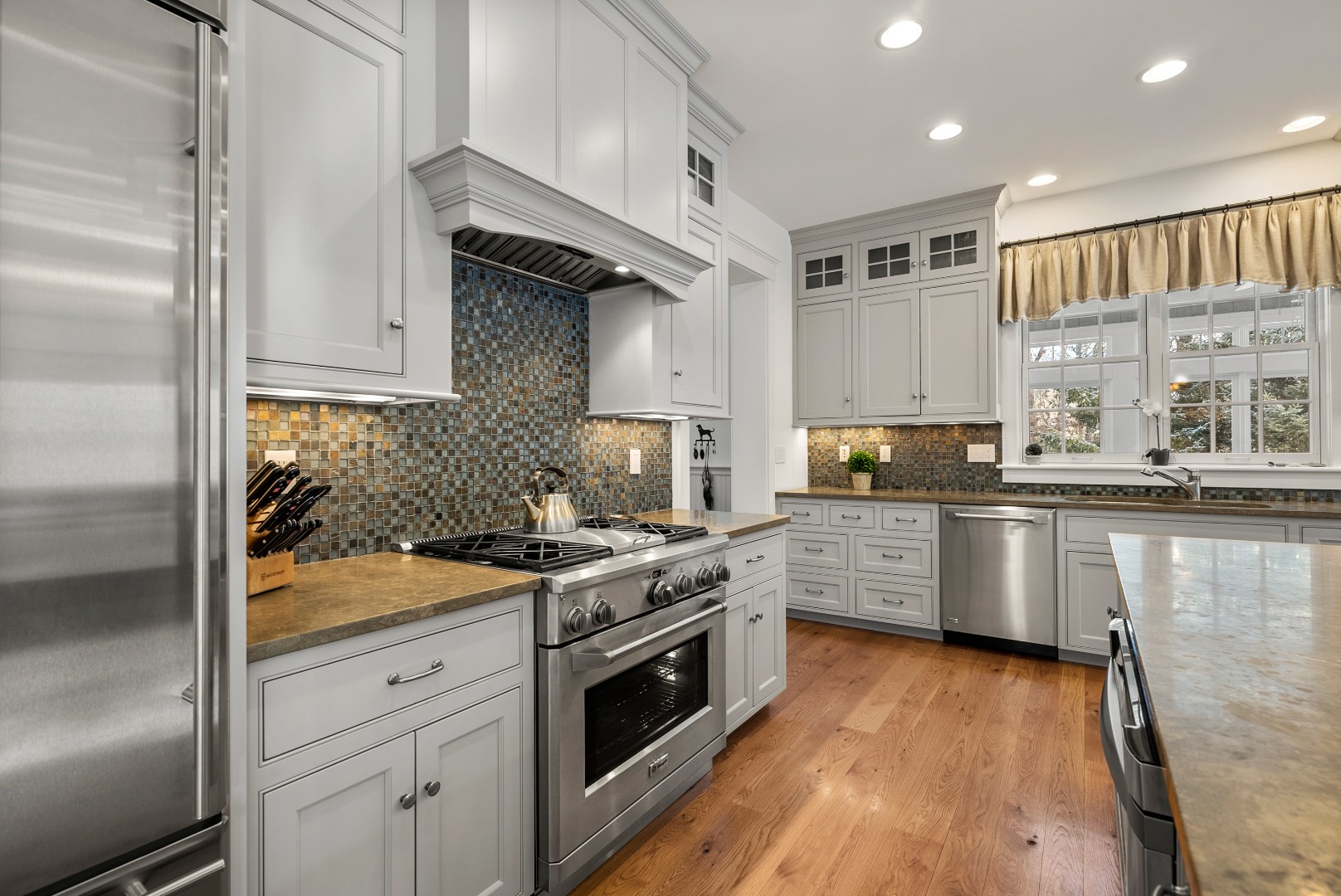 243 Katama Road Edgartown, MA 02539 - Photo 6 of 42 a kitchen with stainless steel appliances granite countertop a stove a sink and a refrigerator