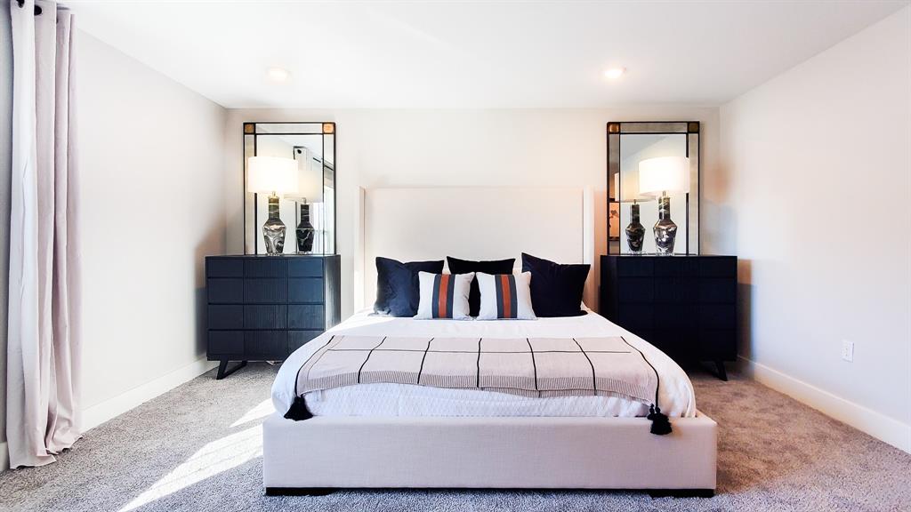 1629 Palladio Loop Princeton, TX 75407 - Photo 5 of 8 a large bed sitting in a bedroom next to a wooden cabinet