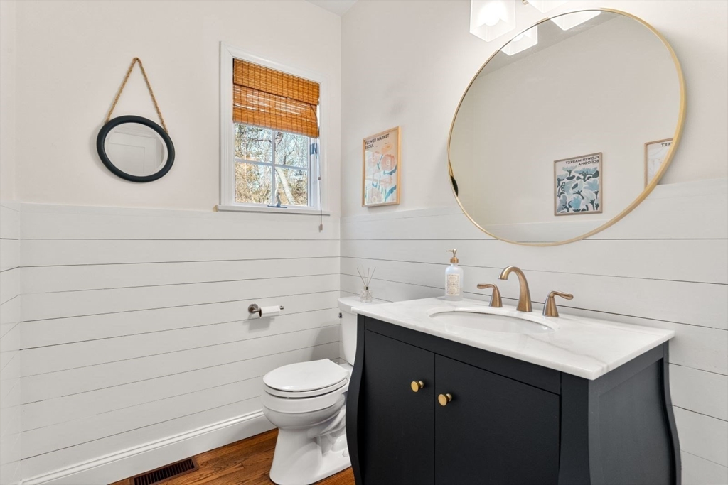 10 Franklin Rodgers Road Hingham, MA 02043 - Photo 17 of 31 a bathroom with a toilet sink vanity and mirror