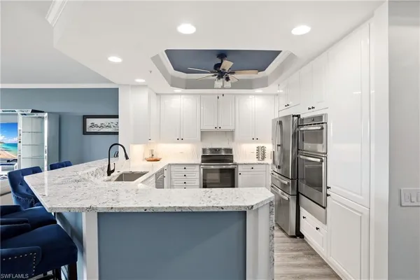 a kitchen with stainless steel appliances granite countertop a sink and refrigerator